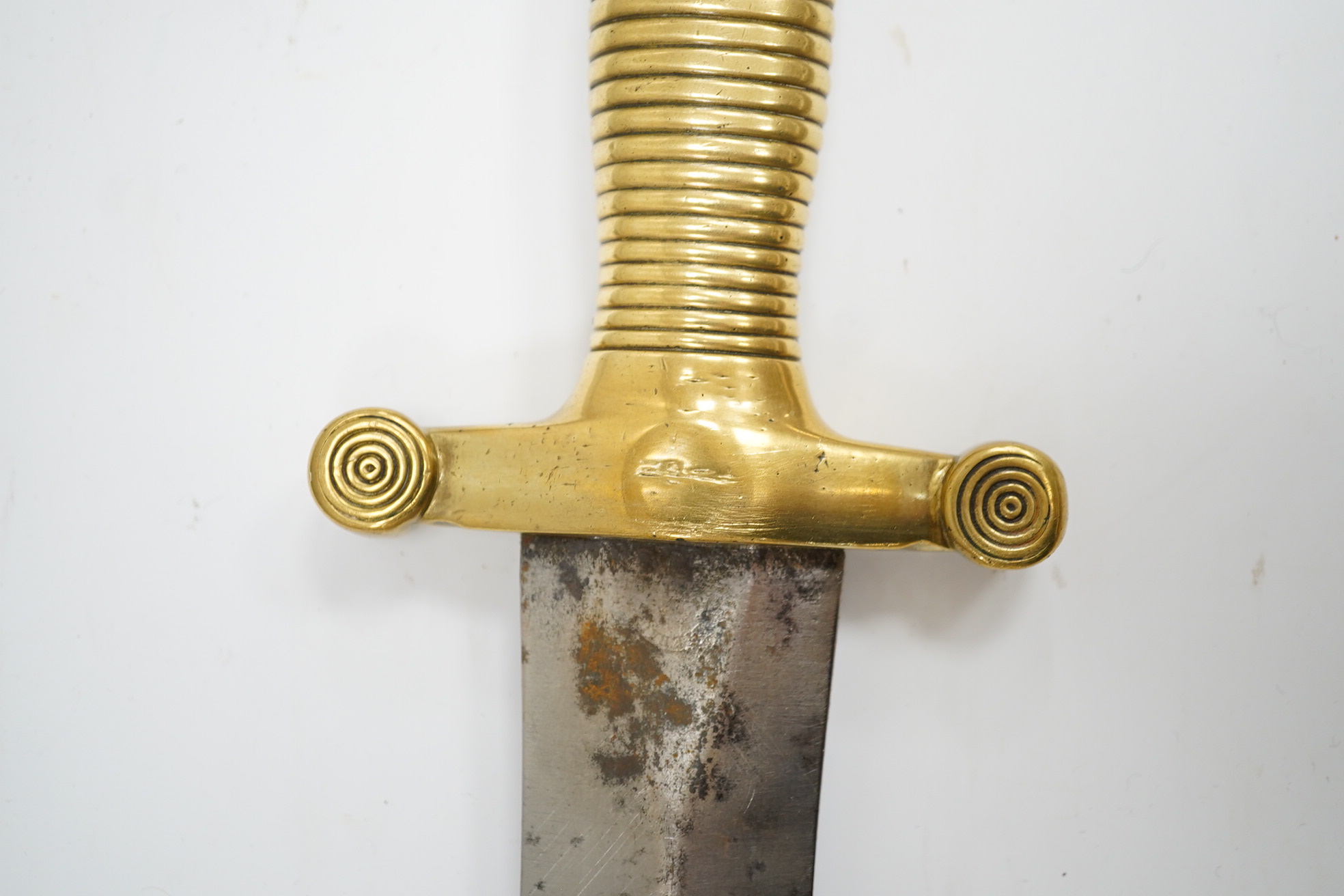 A 19th century French infantryman’s sidearm Gladius with swollen double edged blade, and regulation cast brass cruciform hilt, in its brass mounted leather scabbard, together with a continental bayonet also in scabbard.